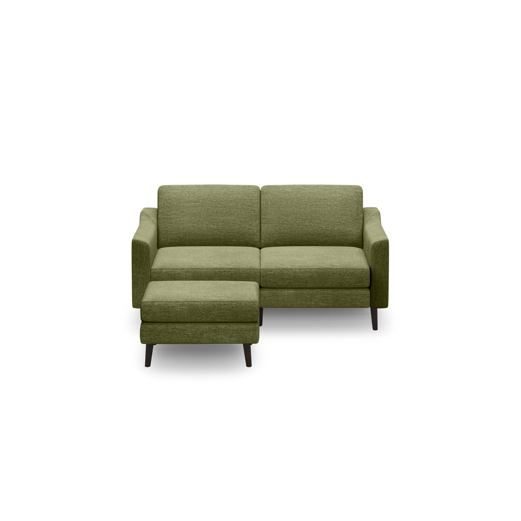 Olive green modern sectional sofa with clean lines, low arms, two back cushions, and a matching ottoman on dark wooden legs.