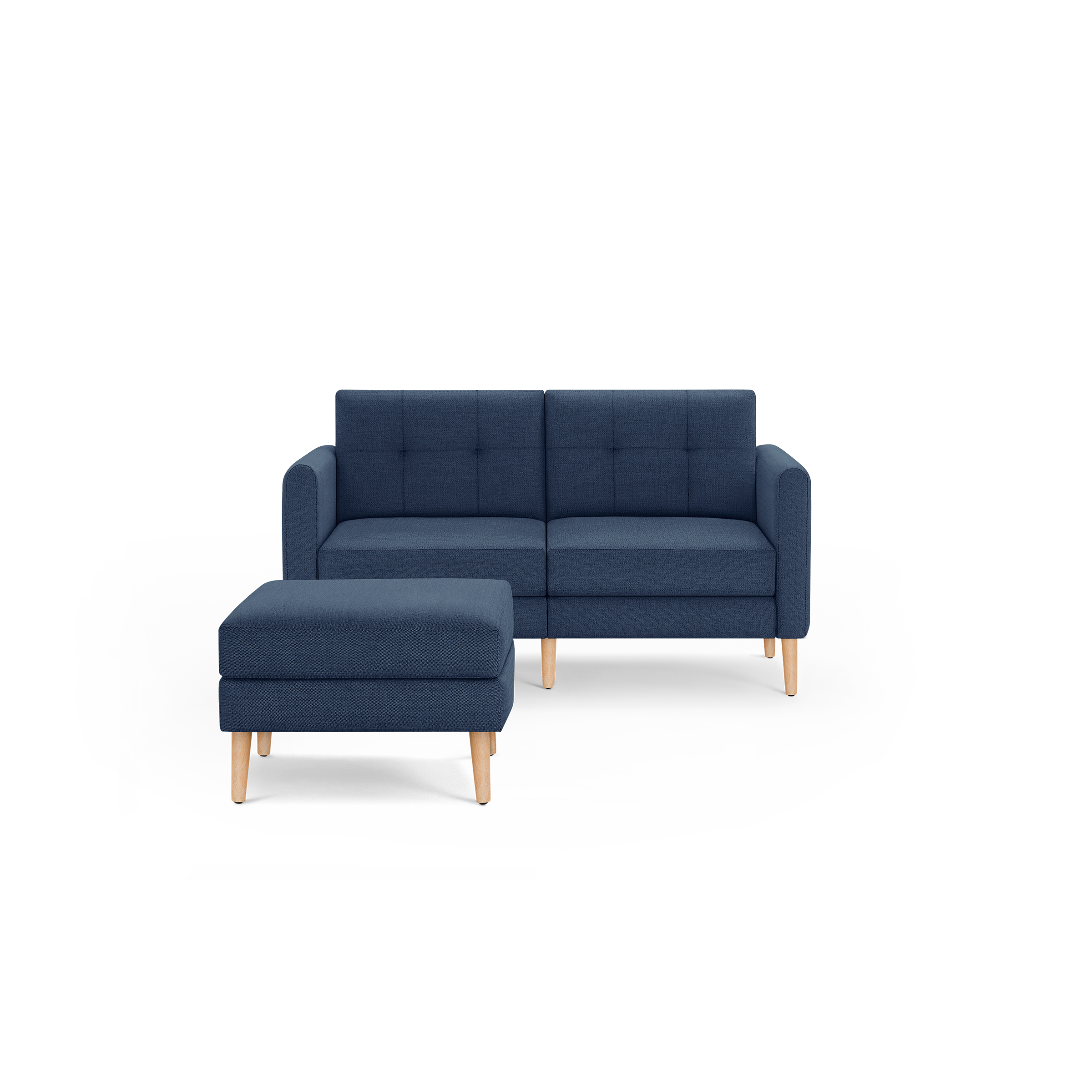 Navy blue modern two-seater sofa with matching ottoman, tufted back cushions, and light wooden legs on black background.