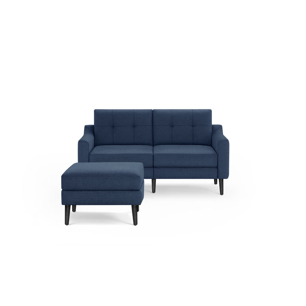 Modern navy blue upholstered loveseat sofa with button-tufted back cushions and matching cushioned ottoman on black legs.