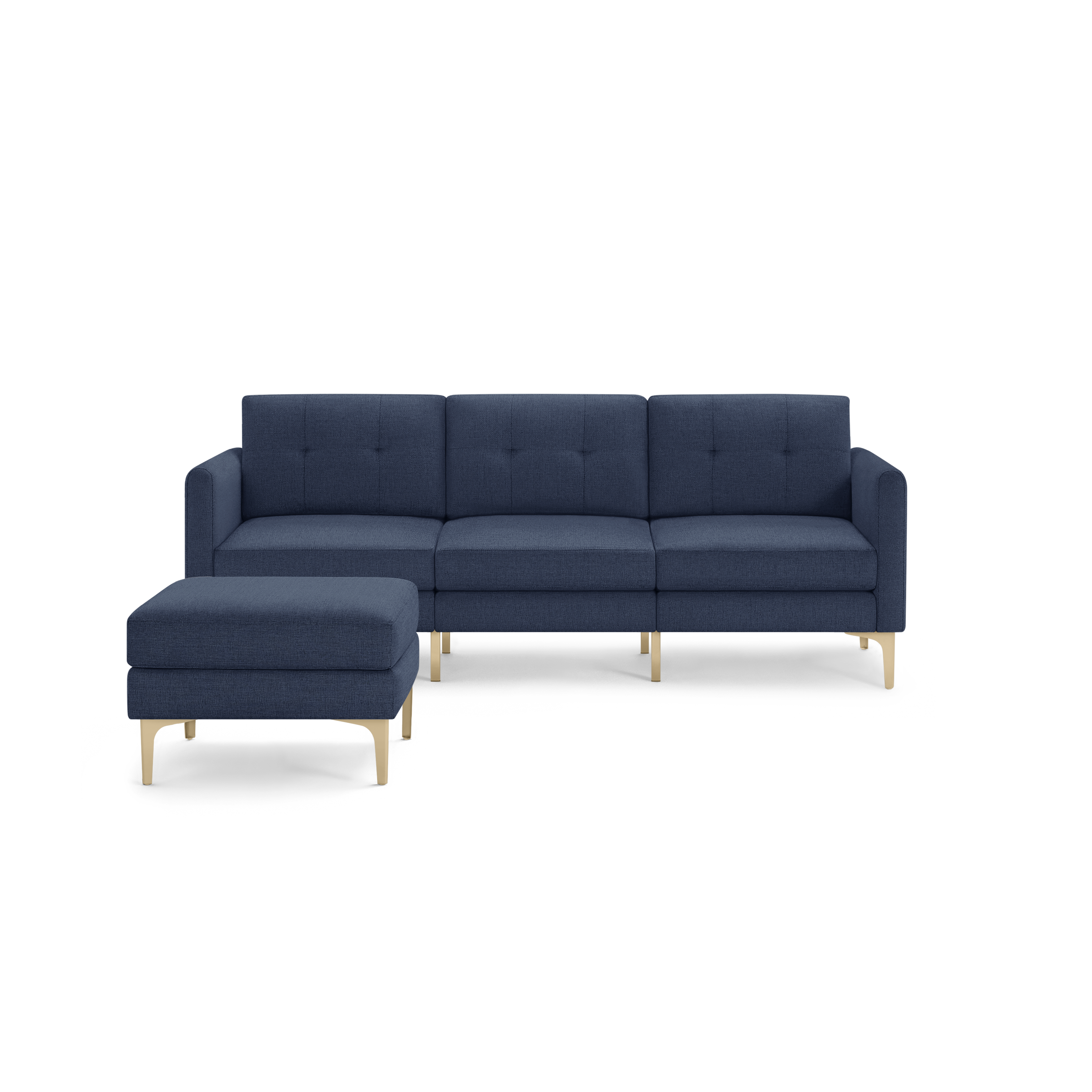 Modern sectional sofa with deep blue fabric upholstery, tufted back cushions, and light wooden legs, including a matching ottoman.