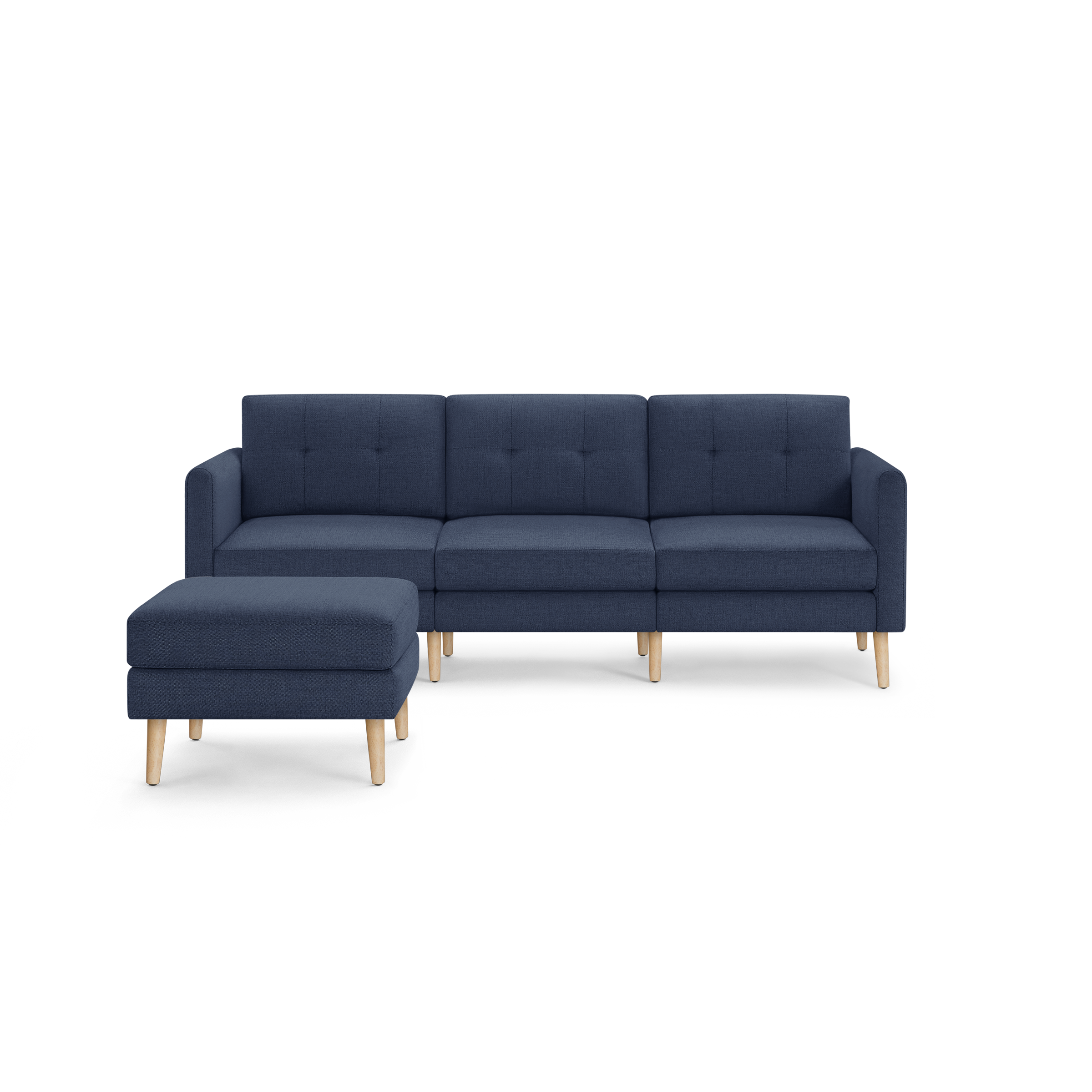 Modern navy blue fabric sectional sofa with a matching ottoman, featuring wooden legs and button-tufted back cushions.
