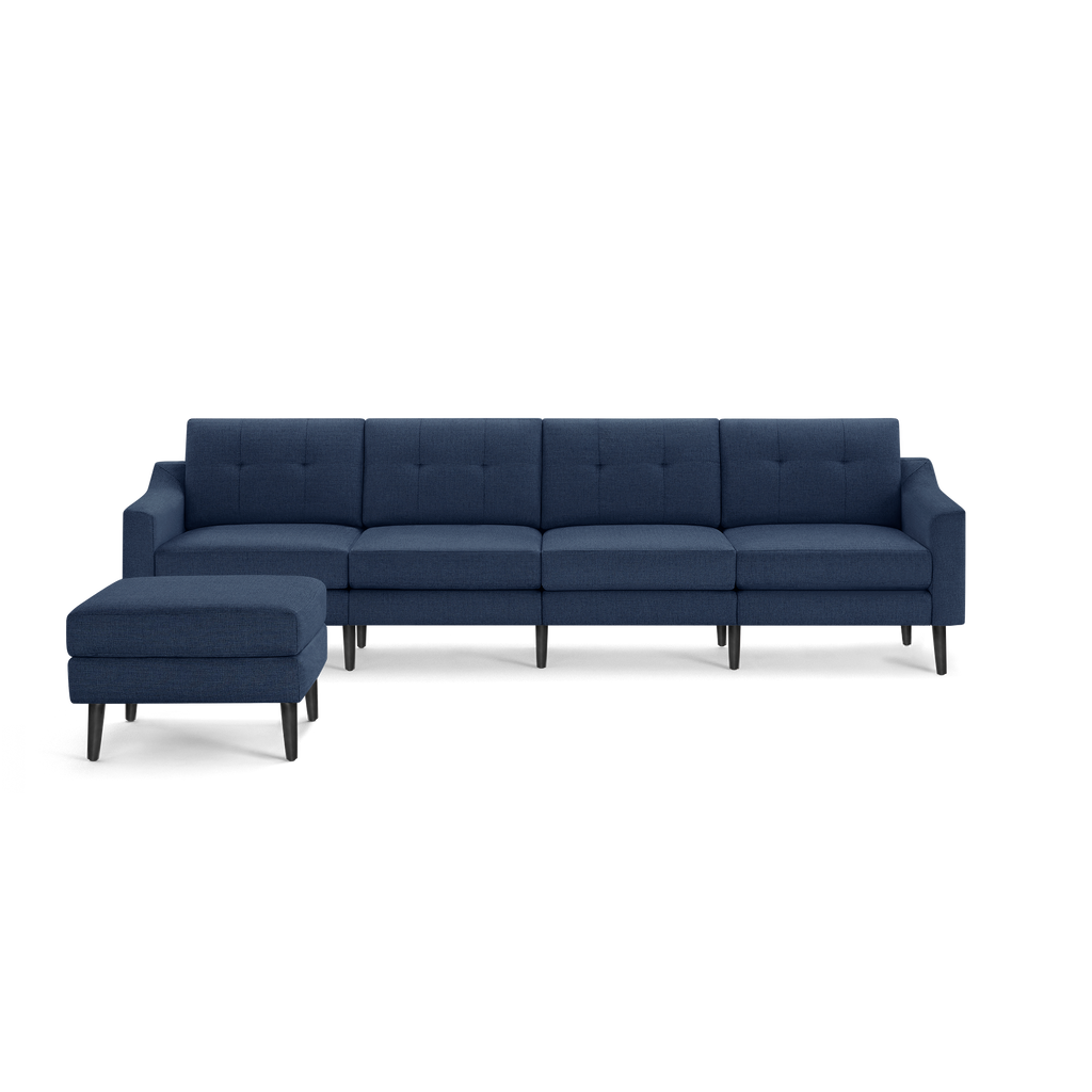 Mid-century modern navy blue fabric sectional sofa with button-tufted backrest and matching ottoman on black tapered wooden legs.