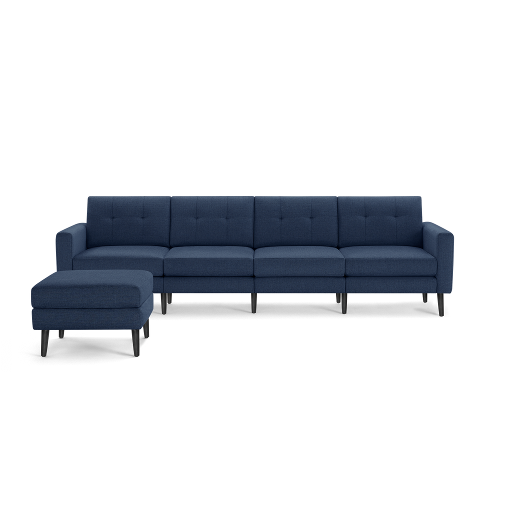 Blue modern sectional sofa with tufted cushions and matching ottoman, featuring dark tapered wooden legs.