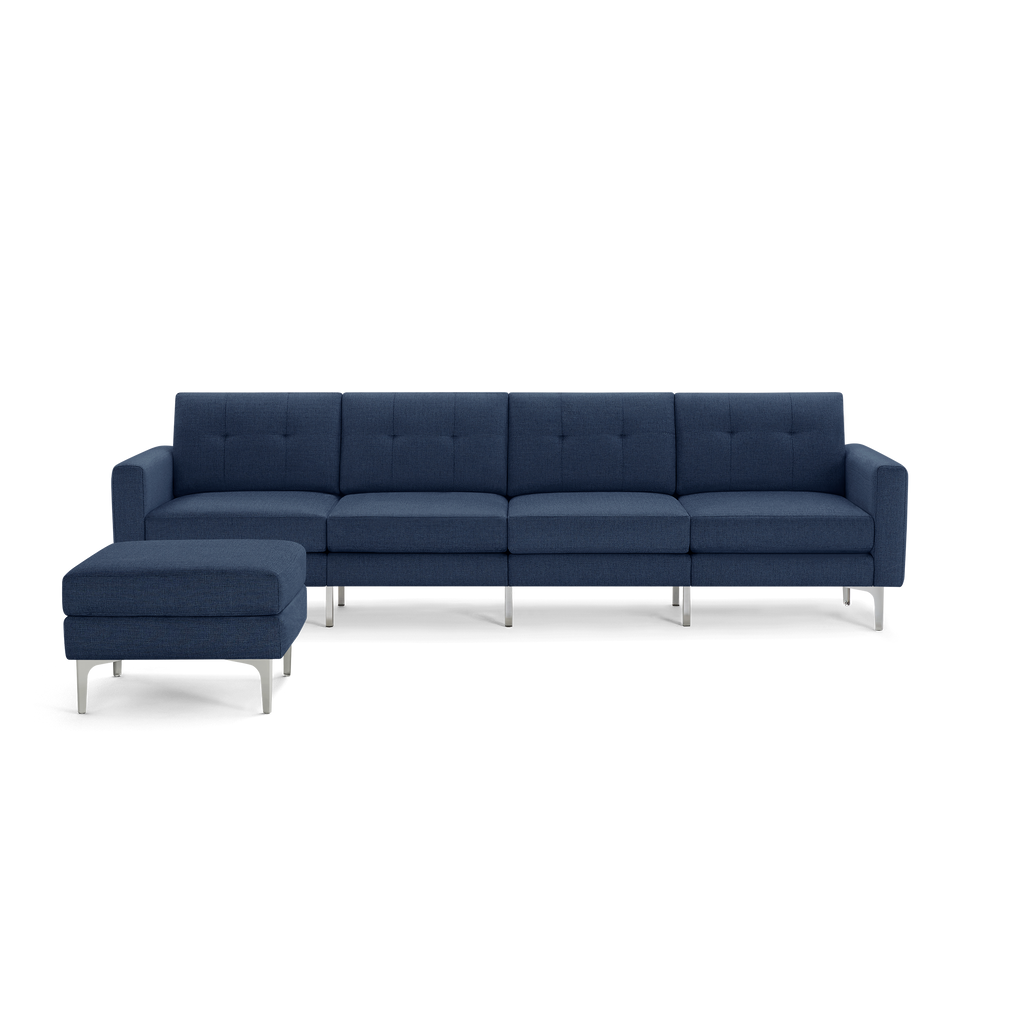 Modern navy blue sectional sofa with tufted cushions, metal legs, and a matching ottoman for extra seating or lounging.
