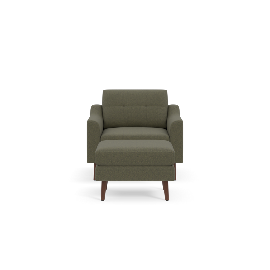 Front view of a modern olive-green upholstered armchair with a matching cushioned ottoman and wooden legs on black background.