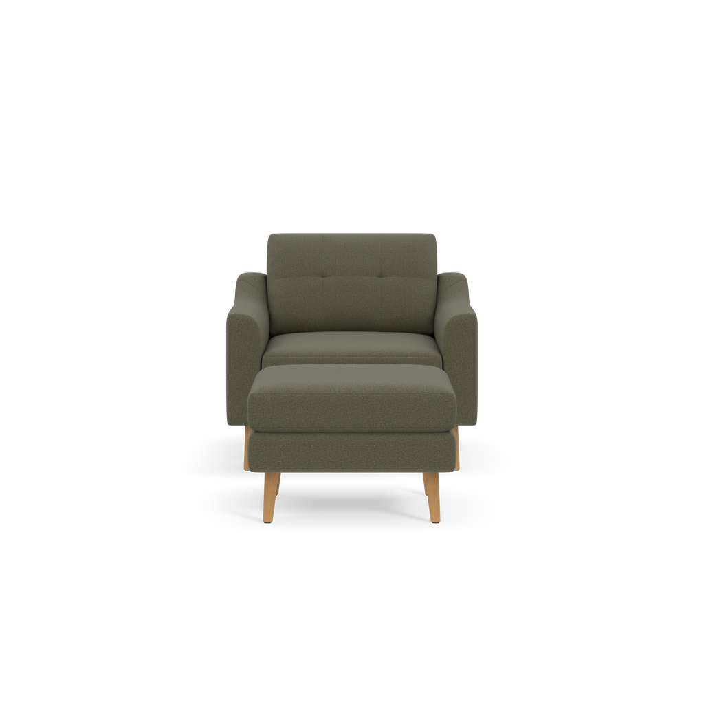 Front view of a modern olive-green upholstered armchair with wooden legs and cushioned seat and backrest against black background.