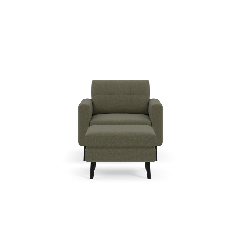 Front view of an Moss green upholstered armchair with cushioned seat and backrest, and black wooden legs.
