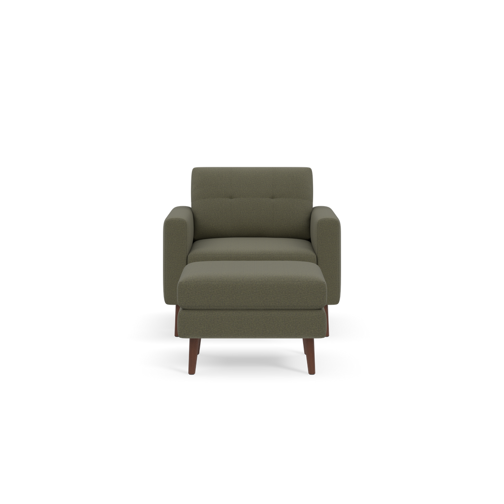 Front view of a modern Moss green armchair with padded seat, backrest, and wooden legs on black background.