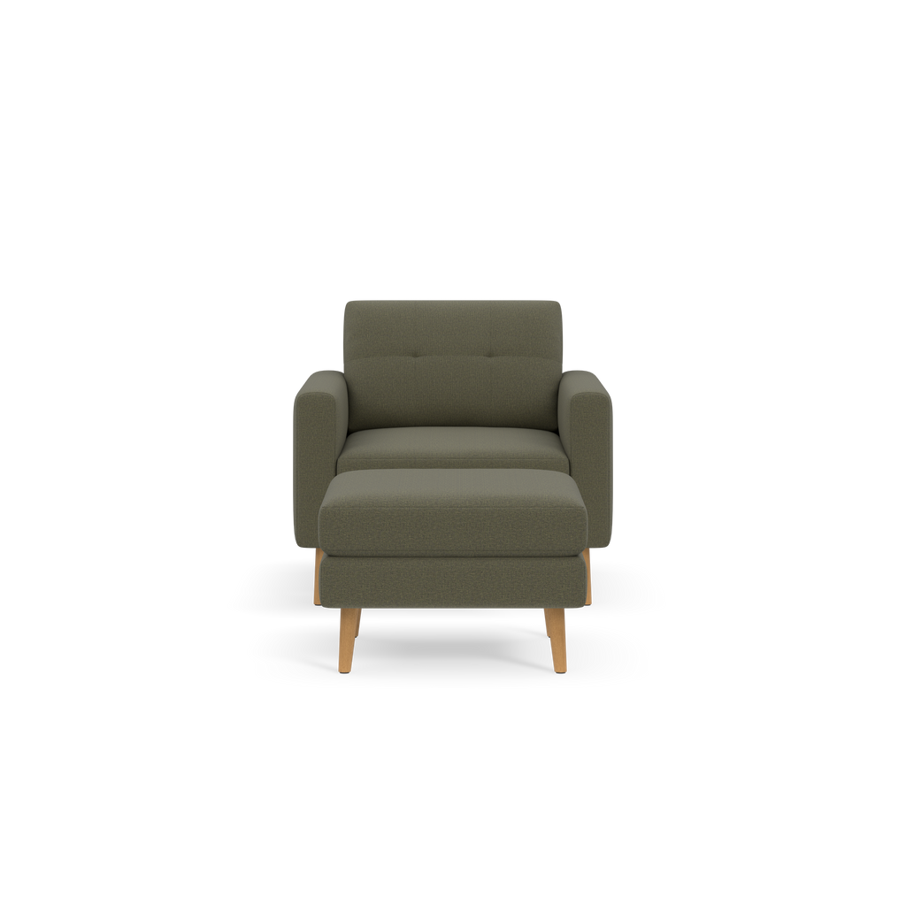Front view of a modern, Moss green upholstered armchair with wooden legs and cushioned armrests.