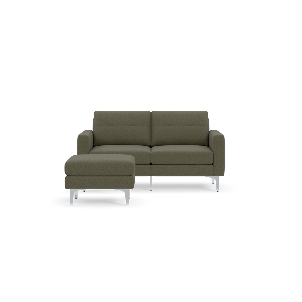 Moss green two-seater sofa with matching chaise lounge, featuring modern clean lines and silver metal legs on black background.