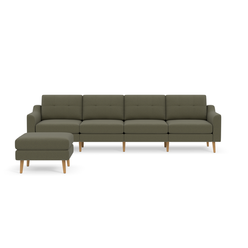 Sectional sofa in muted Moss green fabric with tufted back cushions and light wooden legs, accompanied by a matching ottoman.