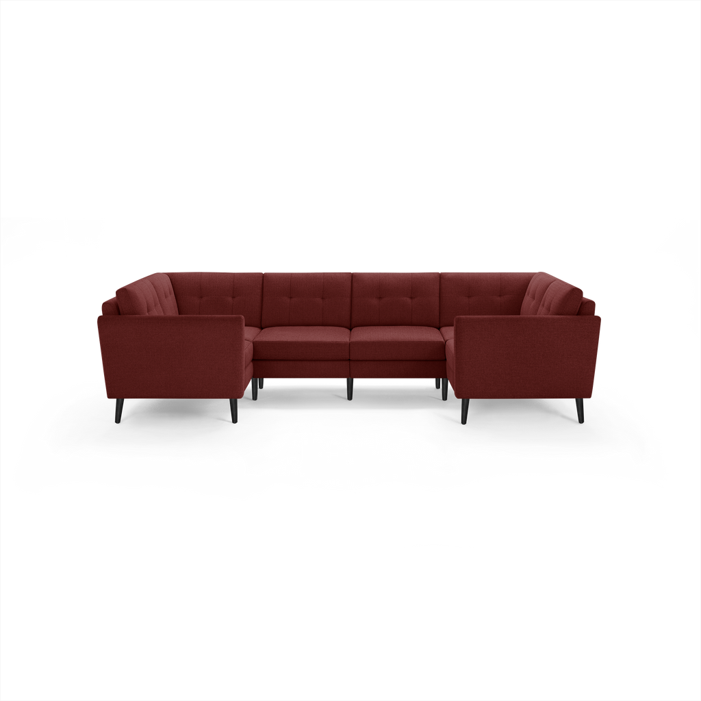 Large modern U-shaped sectional sofa in dark red fabric with tufted cushions and black tapered legs, designed for spacious living rooms.