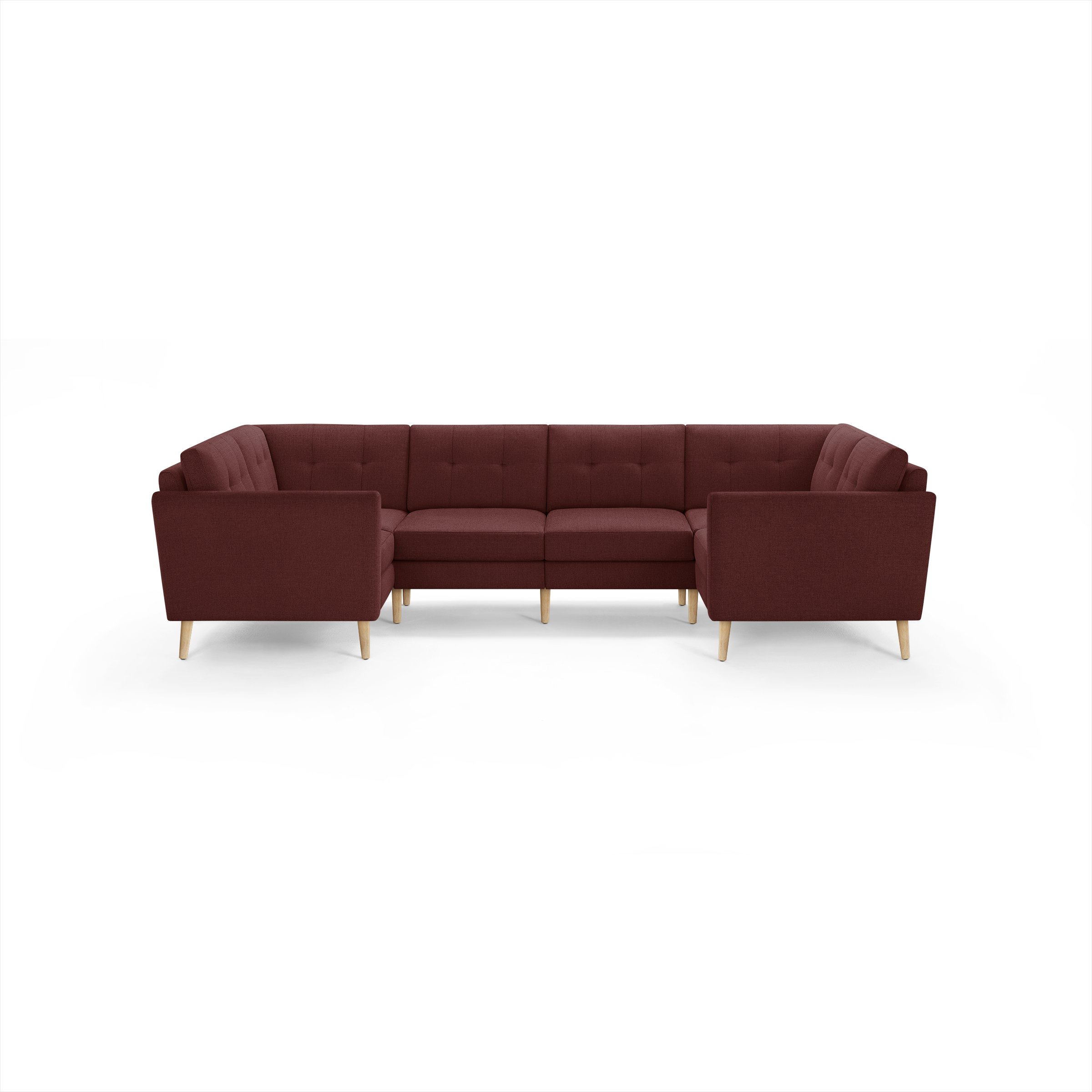Large L-shaped sectional sofa in deep burgundy fabric with tufted cushions and light wooden legs.