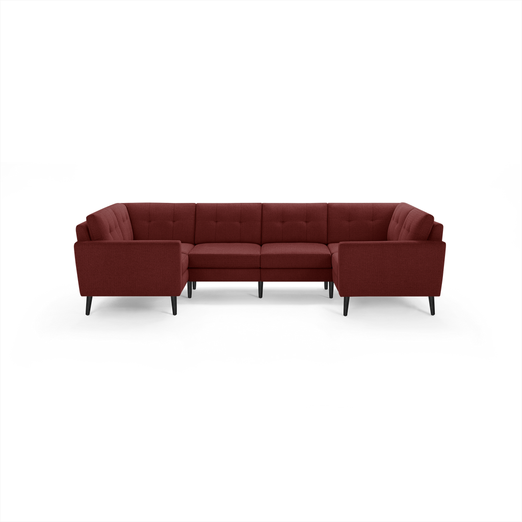 U-shaped sectional sofa in deep burgundy fabric with tufted back cushions and black tapered legs.