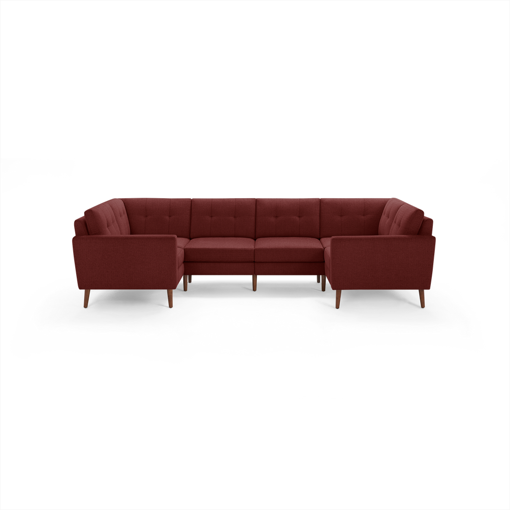 Modern U-shaped sectional sofa in deep red fabric with tufted back cushions and wooden tapered legs.