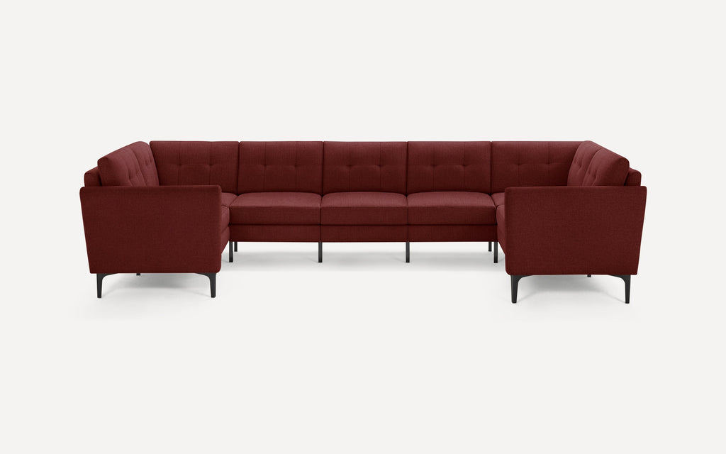 Modern deep red sectional sofa with tufted cushions and slim black metal legs, designed for spacious corner seating.