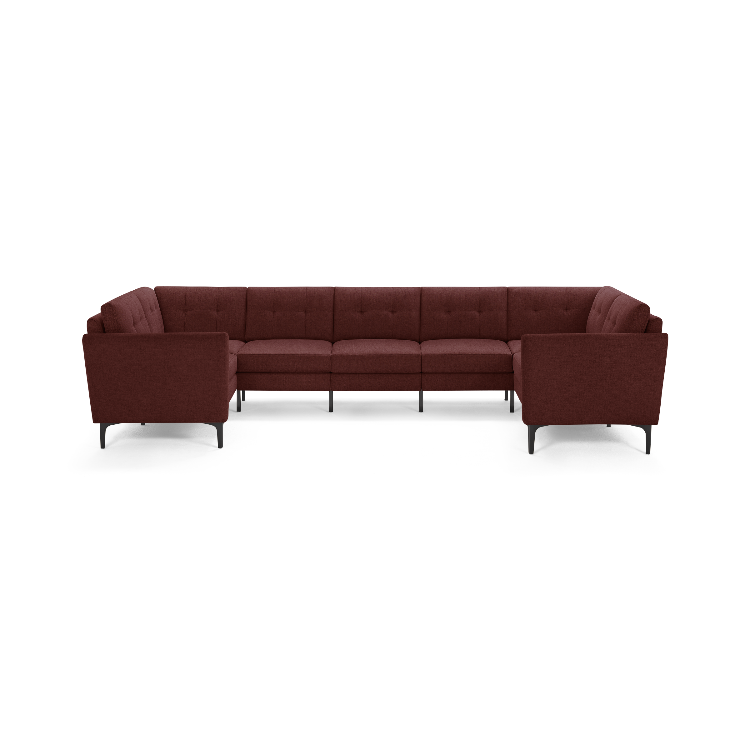 Large modular L-shaped sectional sofa in deep burgundy fabric with tufted cushions and slim black legs.