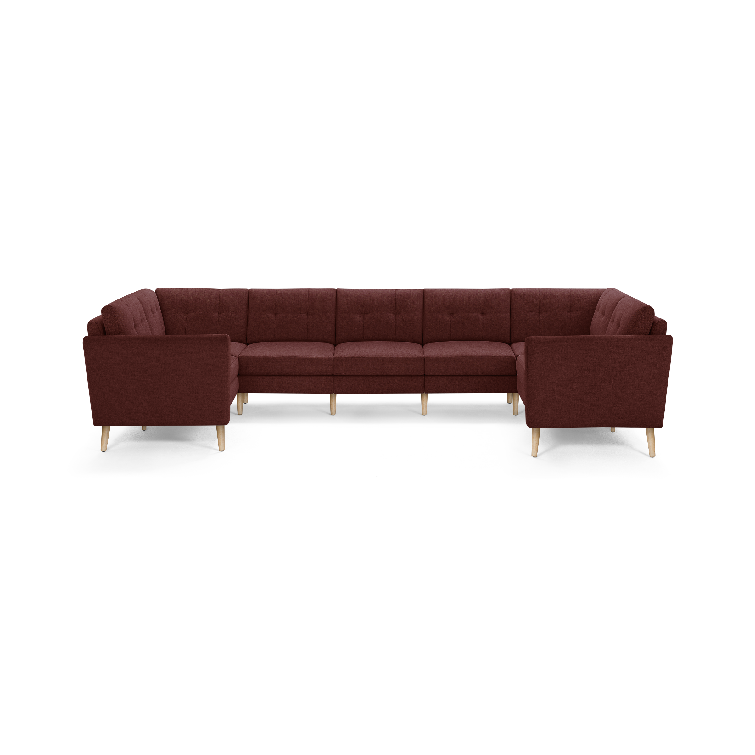 Large U-shaped sectional sofa in deep burgundy fabric with tufted back cushions and light wooden legs.