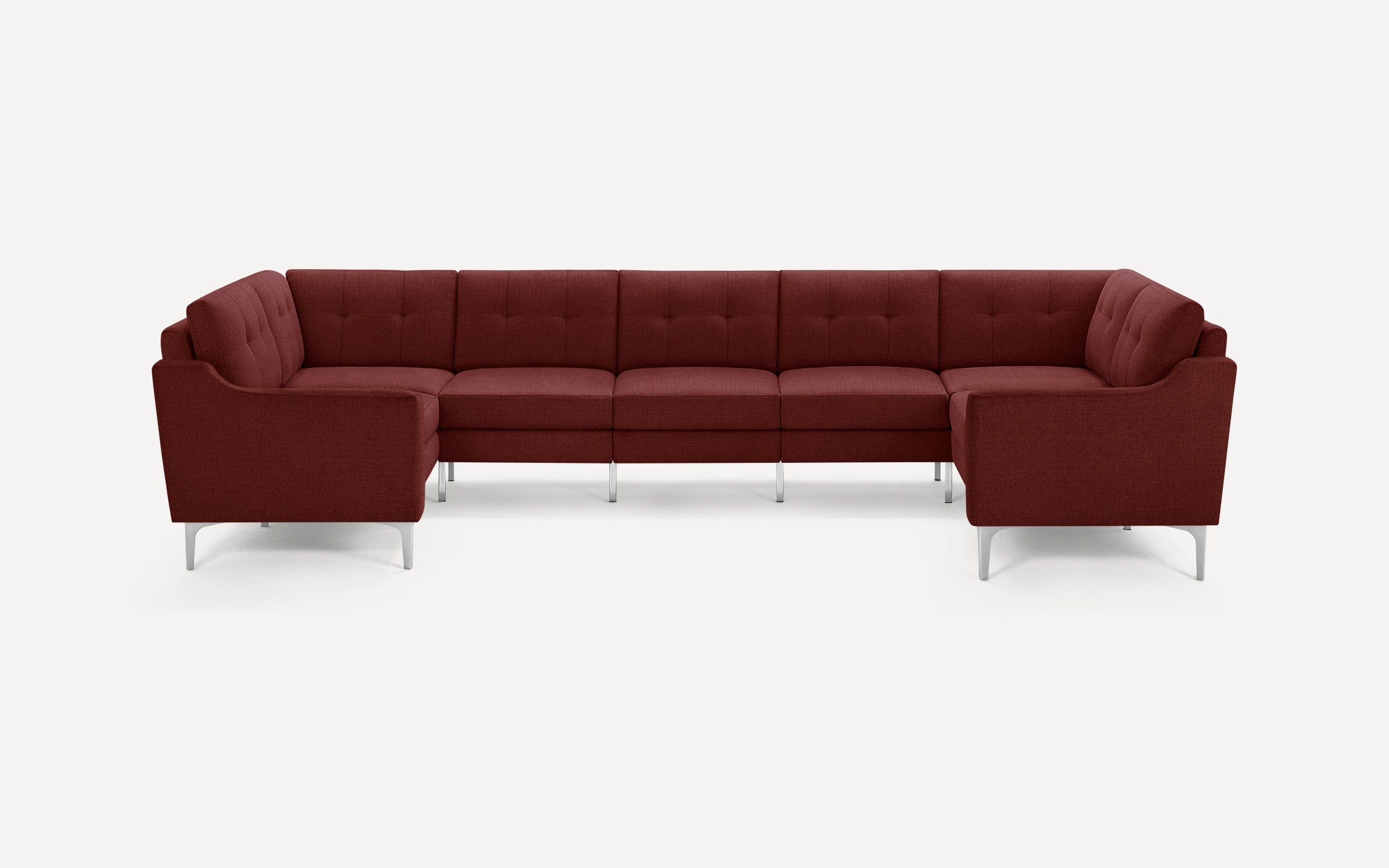 Modern U-shaped sectional sofa in deep burgundy fabric with metal legs and tufted cushions, designed for spacious seating.