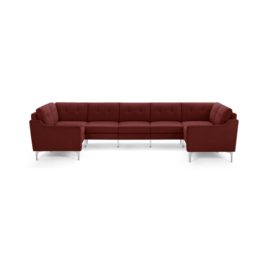 Large deep red L-shaped sectional sofa with tufted back cushions and sleek silver metal legs on a white background.