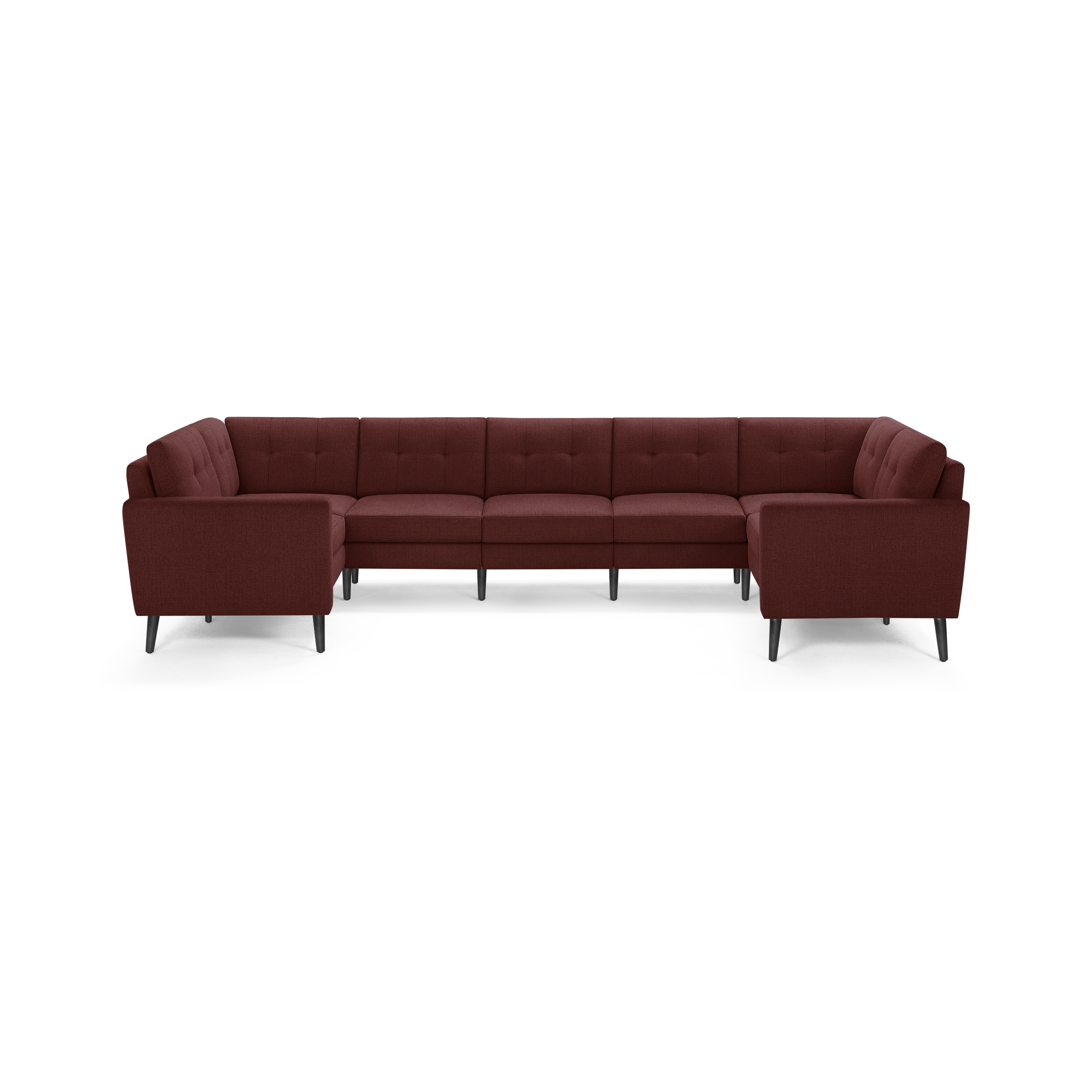 Large modern U-shaped sectional sofa upholstered in dark red fabric with tufted back cushions and slim dark legs.