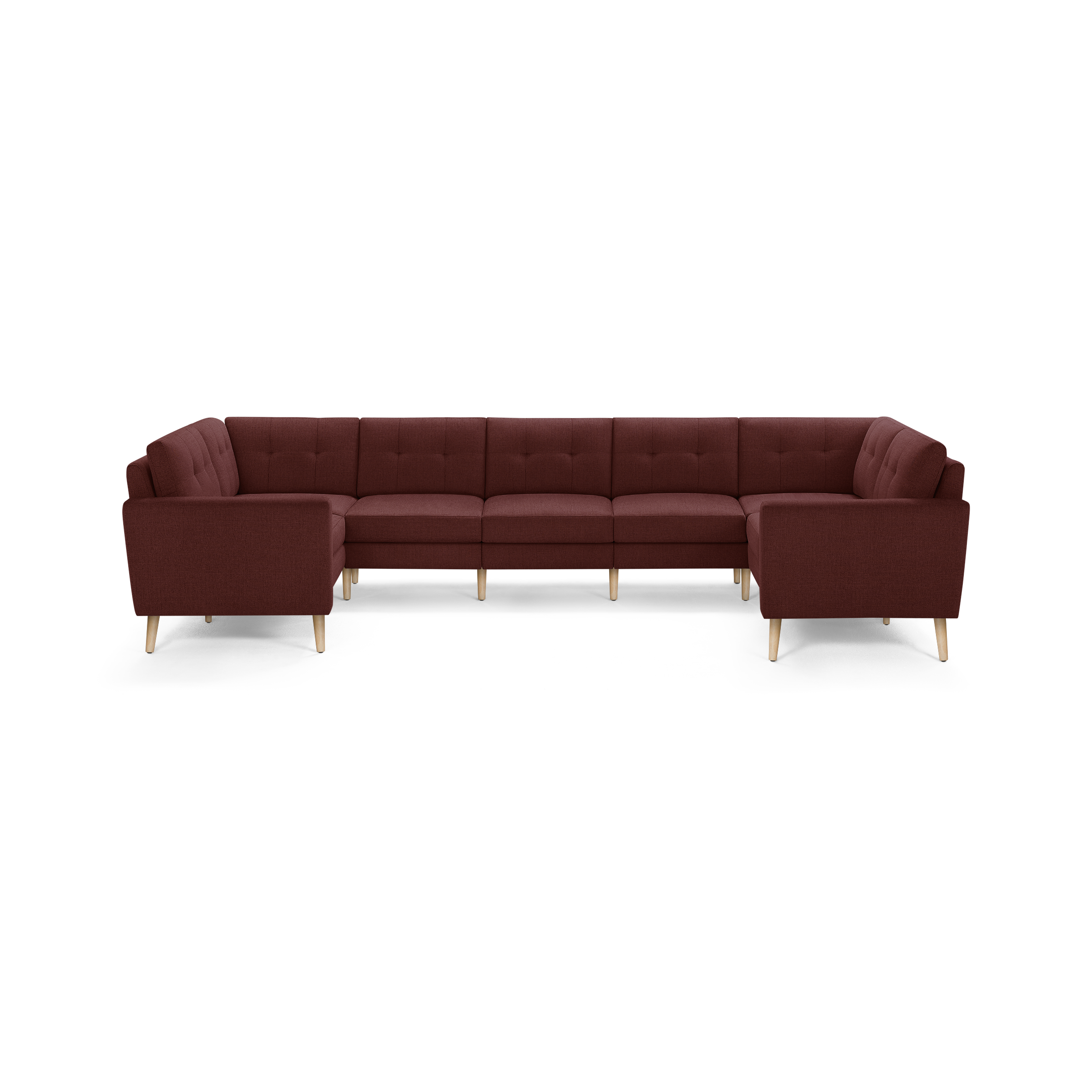 Large U-shaped sectional sofa with deep red fabric upholstery, tufted back cushions, and light wooden tapered legs.