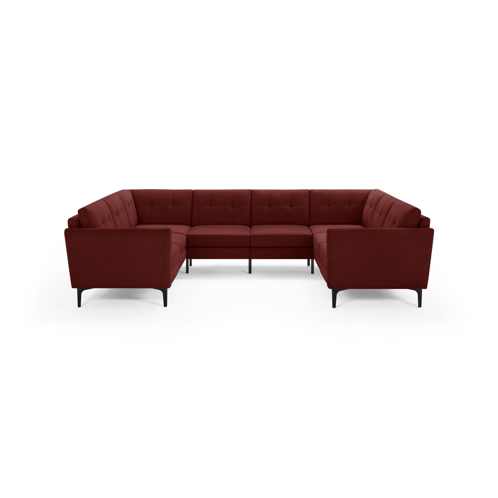 U-shaped sectional sofa in rich burgundy fabric with tufted cushioning and slim black metal legs, designed for spacious seating.