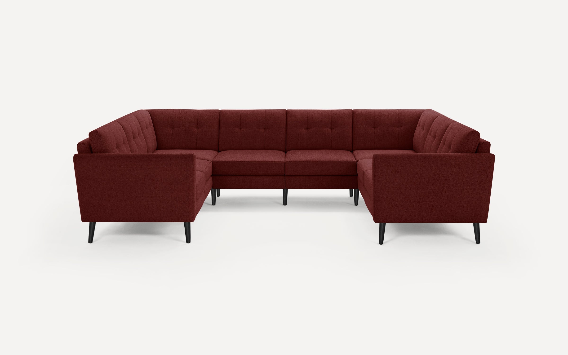Maroon fabric sectional sofa with tufted backrests and straight armrests, supported by slim black tapered legs.
