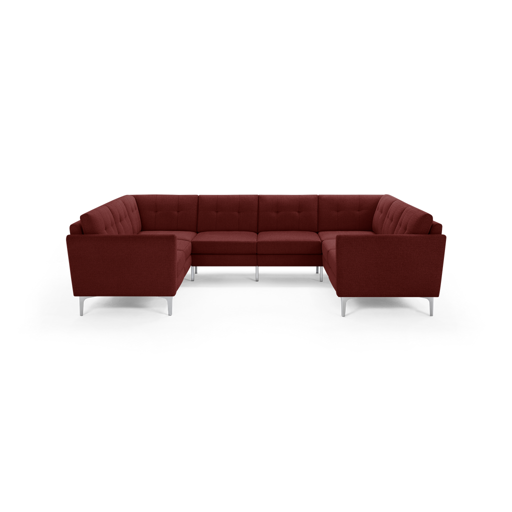 Large modern U-shaped sectional sofa in deep red fabric with tufted cushions and slim silver legs, designed for spacious living rooms.