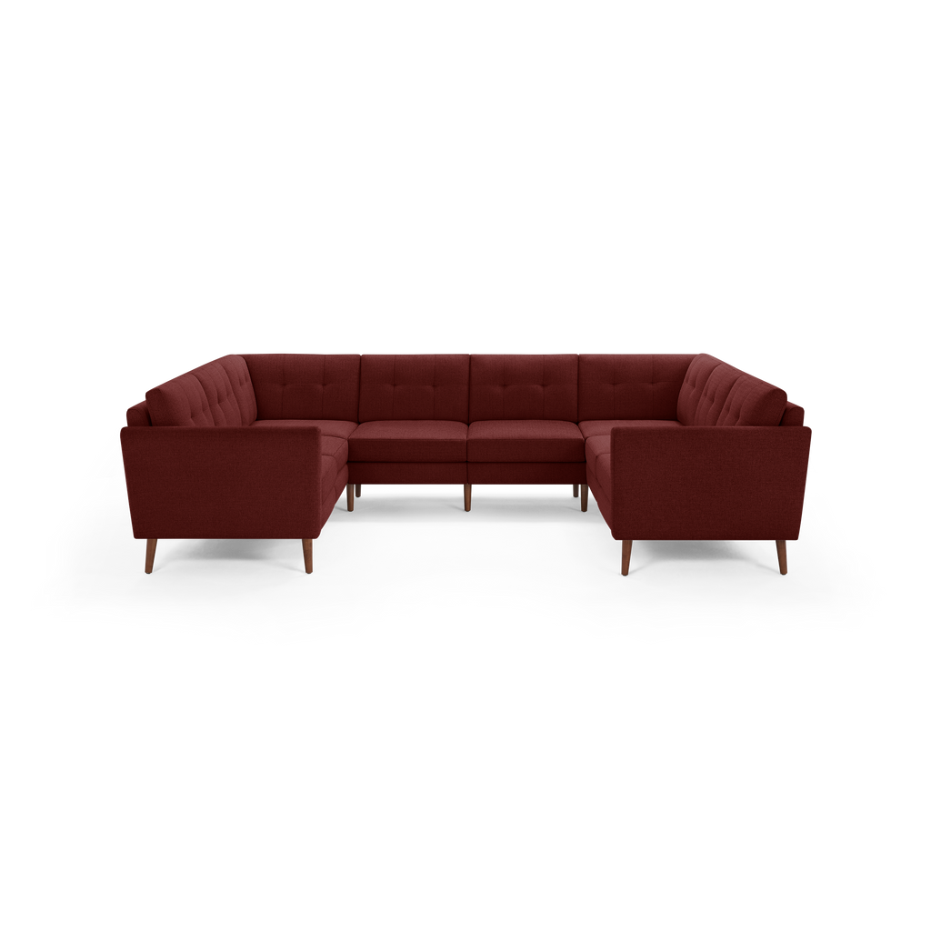 Large U-shaped sectional sofa with tufted back cushions and wooden legs, upholstered in rich burgundy fabric.
