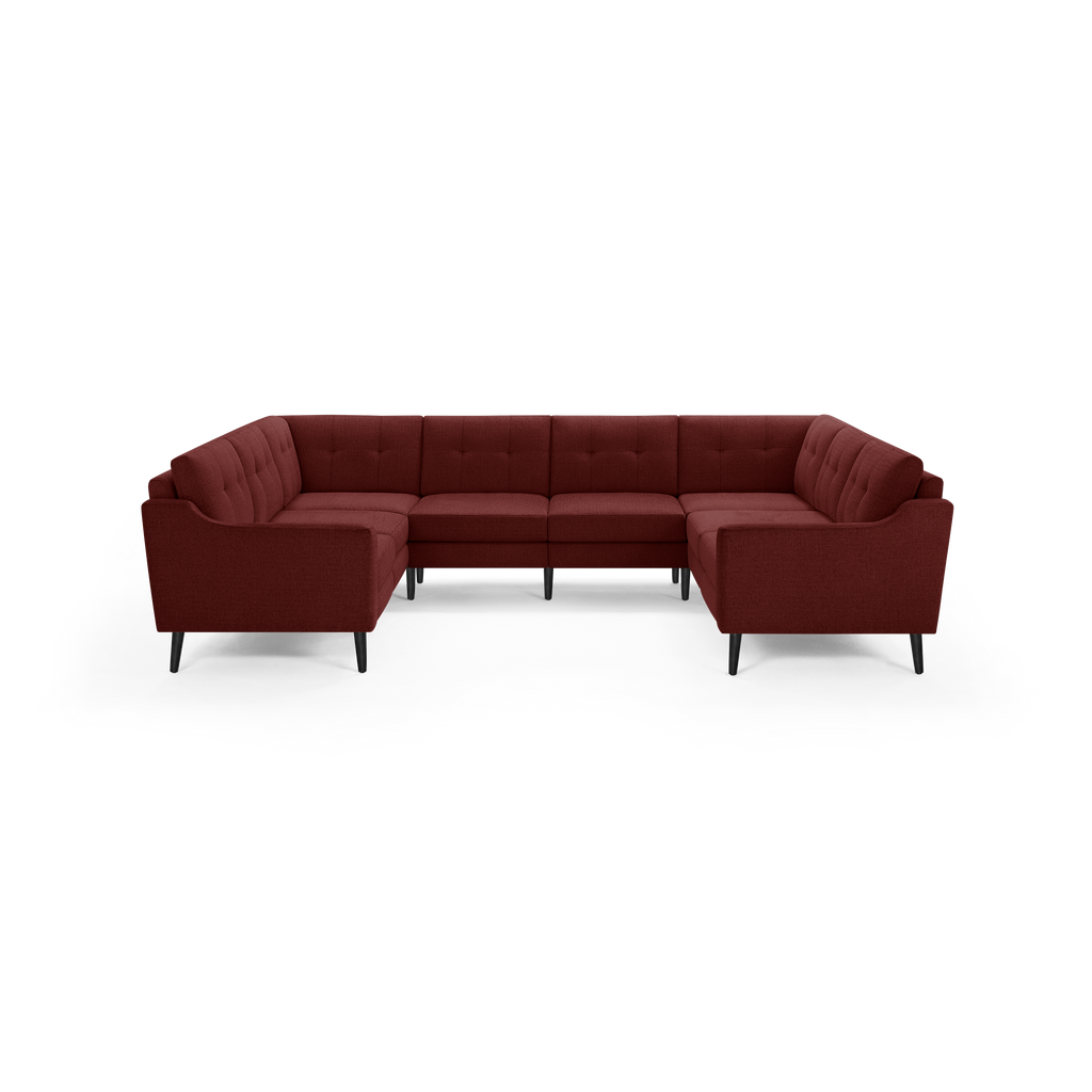 Large sectional sofa in deep red fabric with tufted back cushions and black tapered legs, designed for spacious seating.
