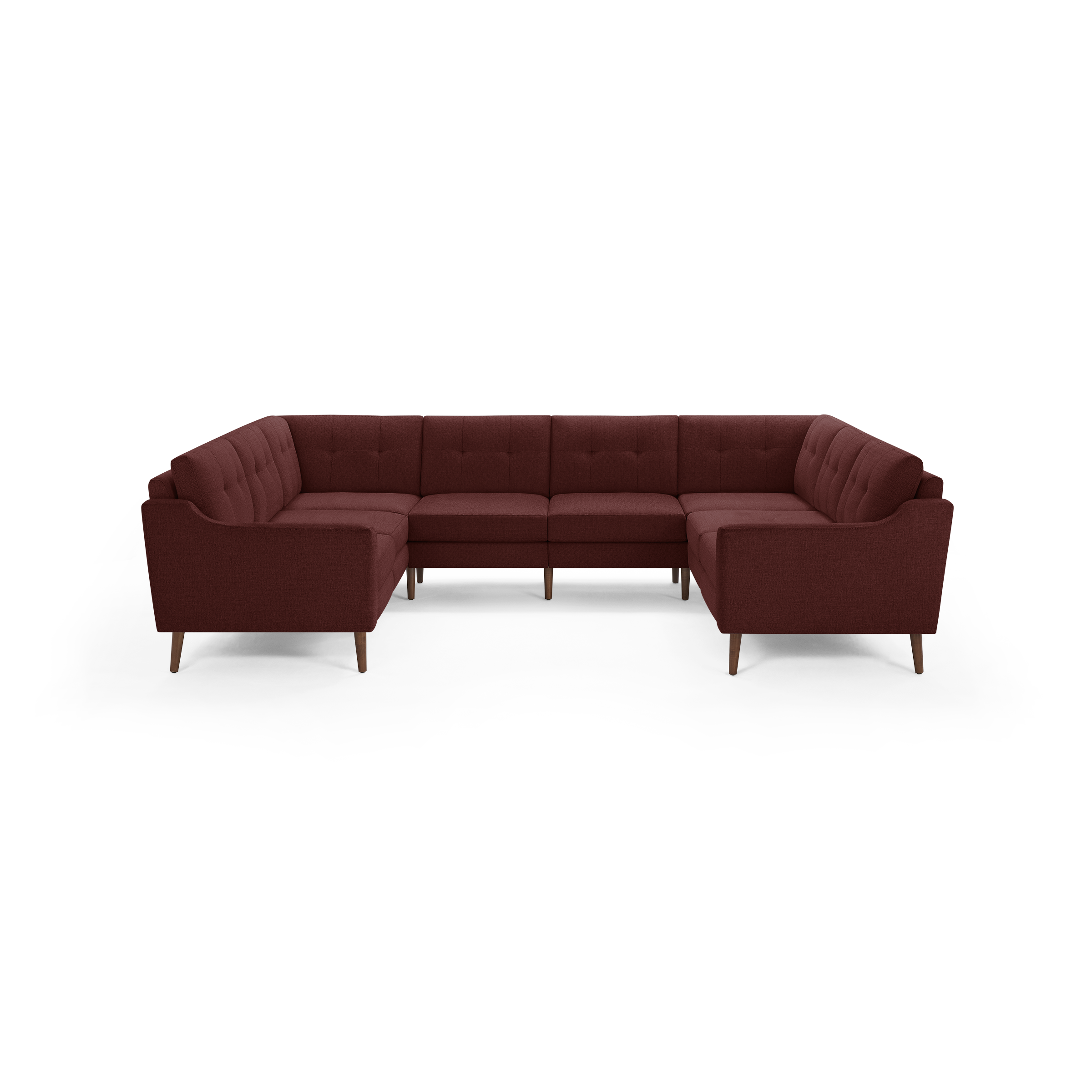 Mid-century modern U-shaped sectional sofa in deep red fabric with tufted back cushions and wooden legs.