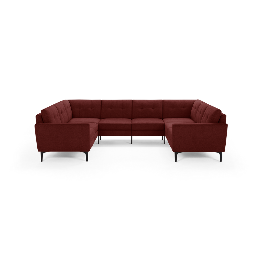 U-shaped sectional sofa in dark red fabric with tufted cushions and slim black metal legs, modern design.