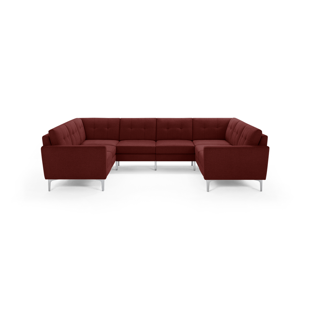 Large modern U-shaped sectional sofa in deep red fabric with tufted cushions and slim silver metal legs.