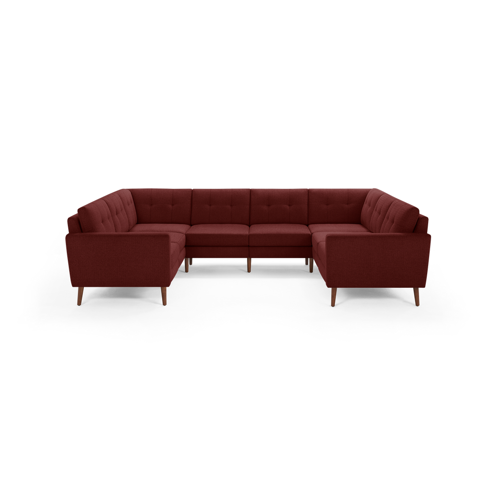 Modern U-shaped sectional sofa with deep red fabric upholstery, tufted back cushions, and wooden tapered legs.