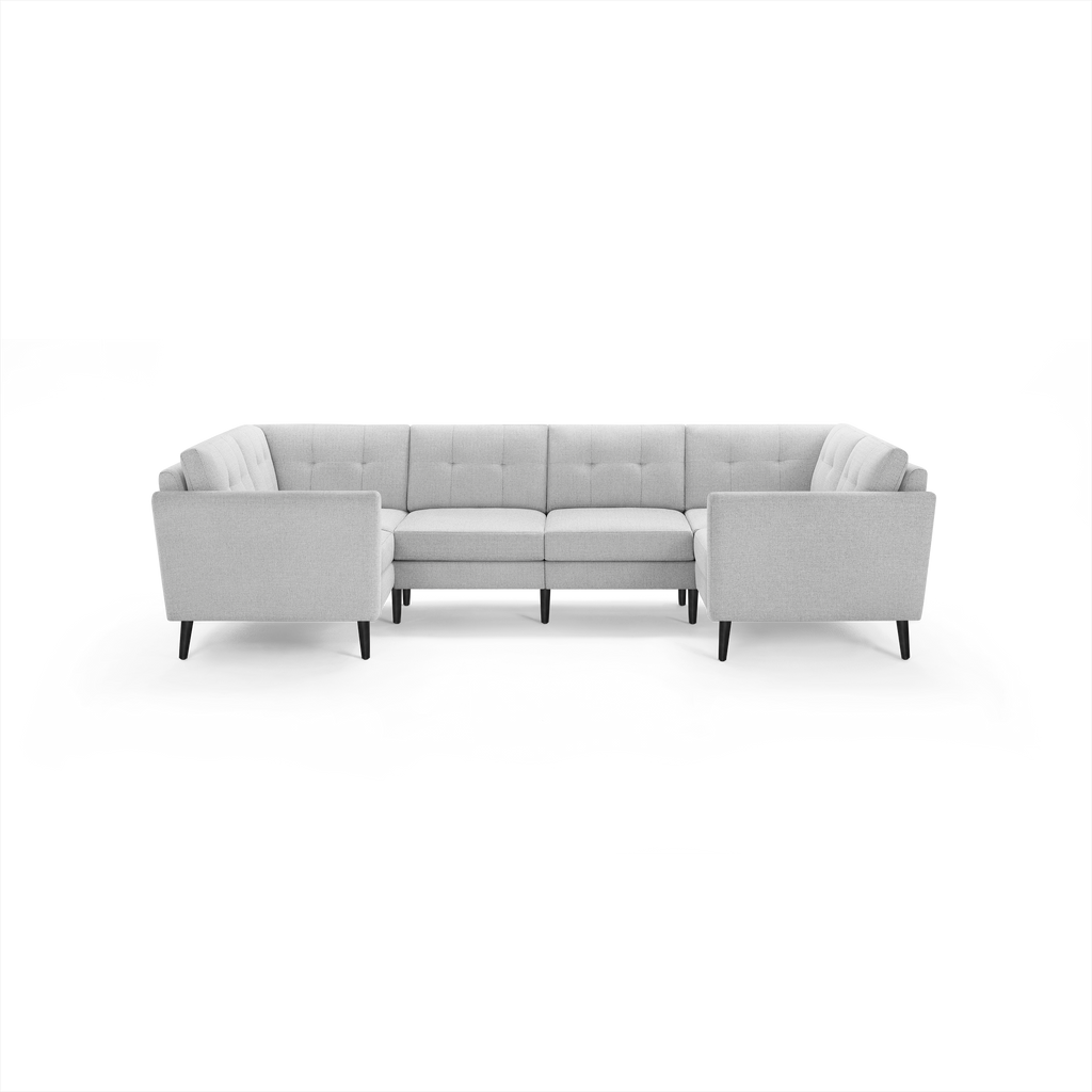 Light gray fabric sectional sofa with tufted back cushions, clean lines, and dark wooden legs.