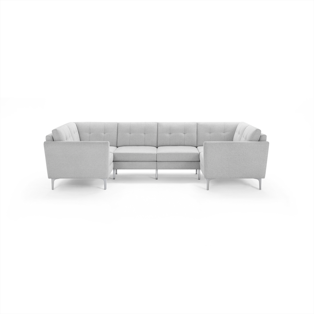 Light gray modern U-shaped sectional sofa with tufted back cushions and slim legs, designed for spacious seating.