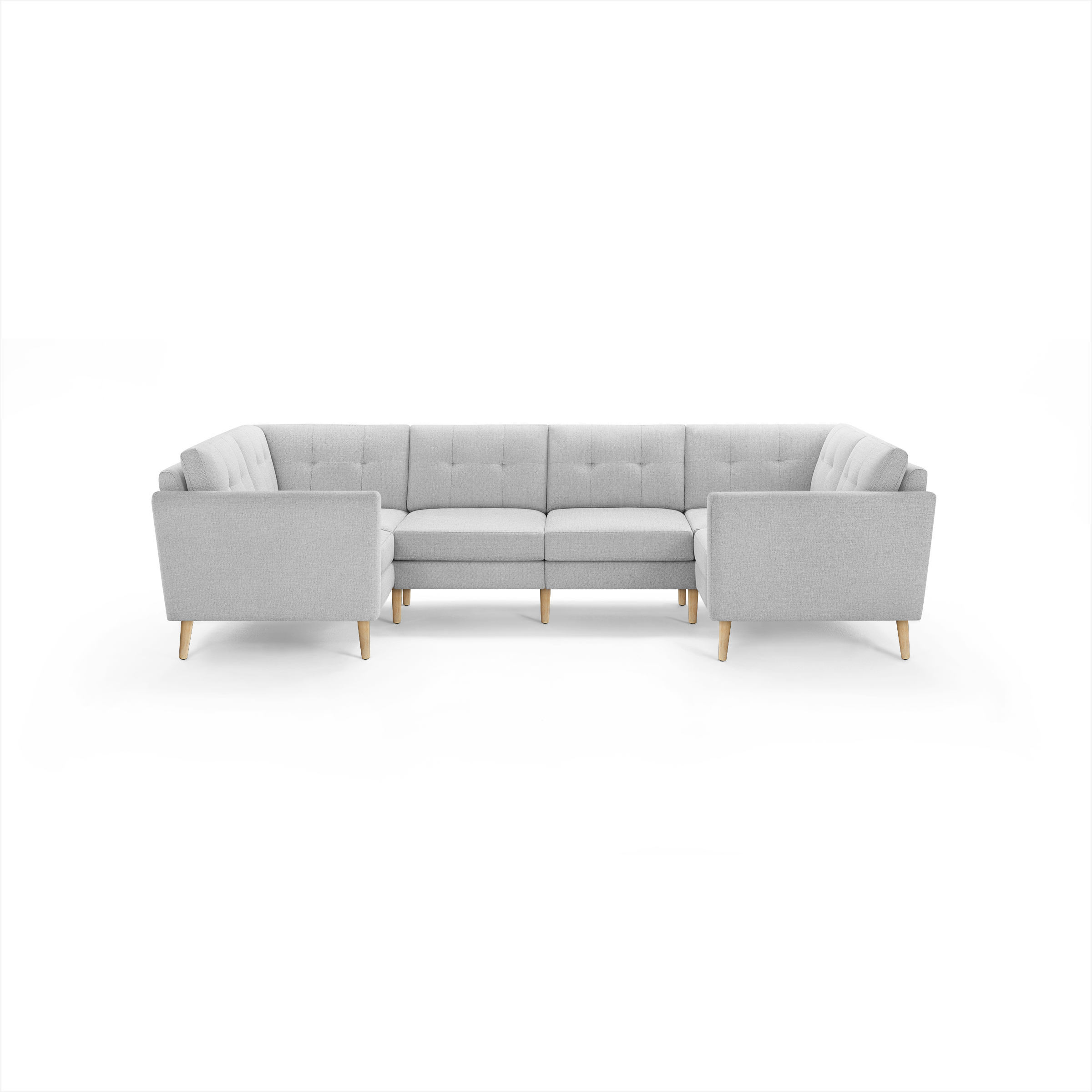 Light gray fabric sectional sofa with wooden legs, tufted back cushions, and modern, clean-lined design.