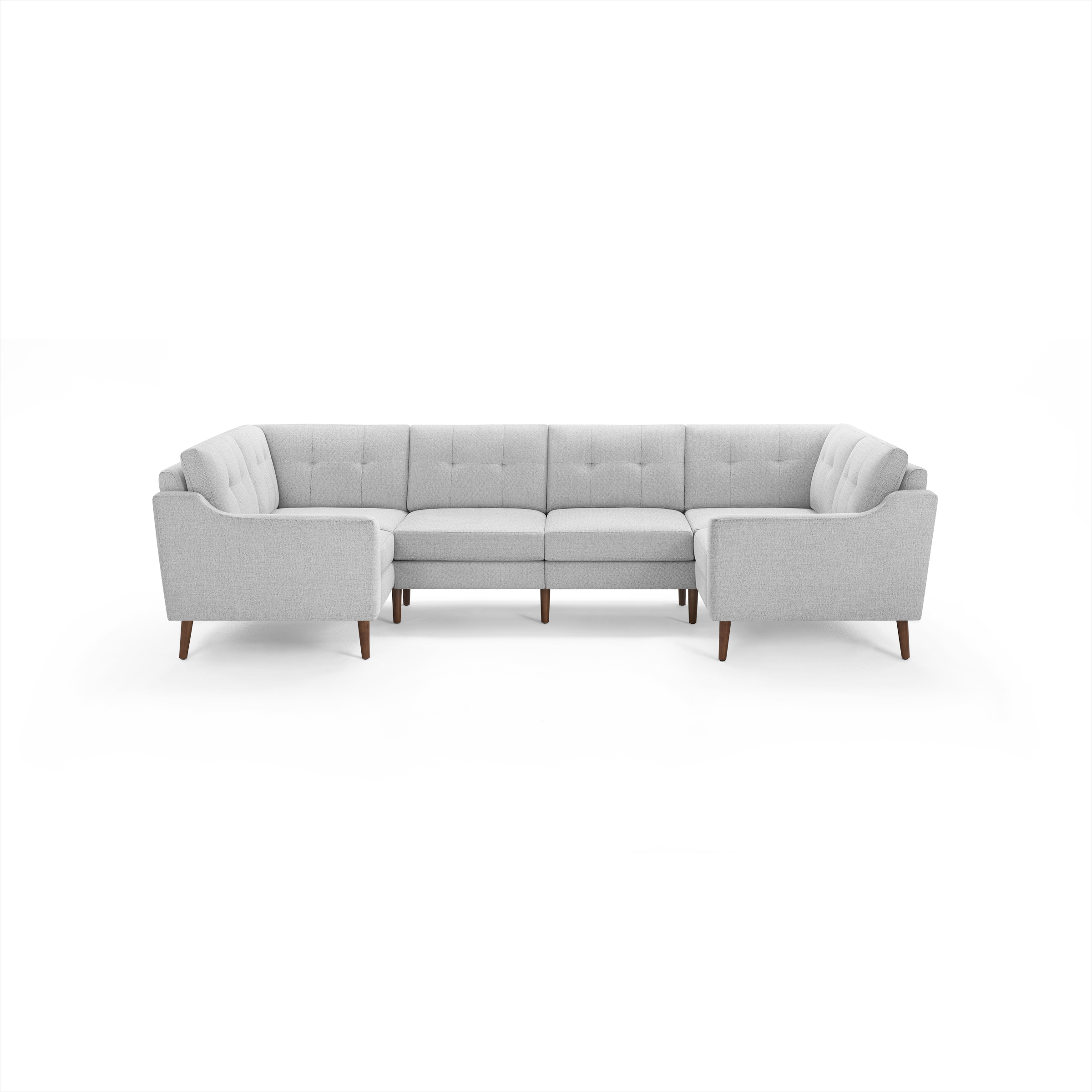 Light gray fabric U-shaped sectional sofa with tufted back cushions and wooden legs.