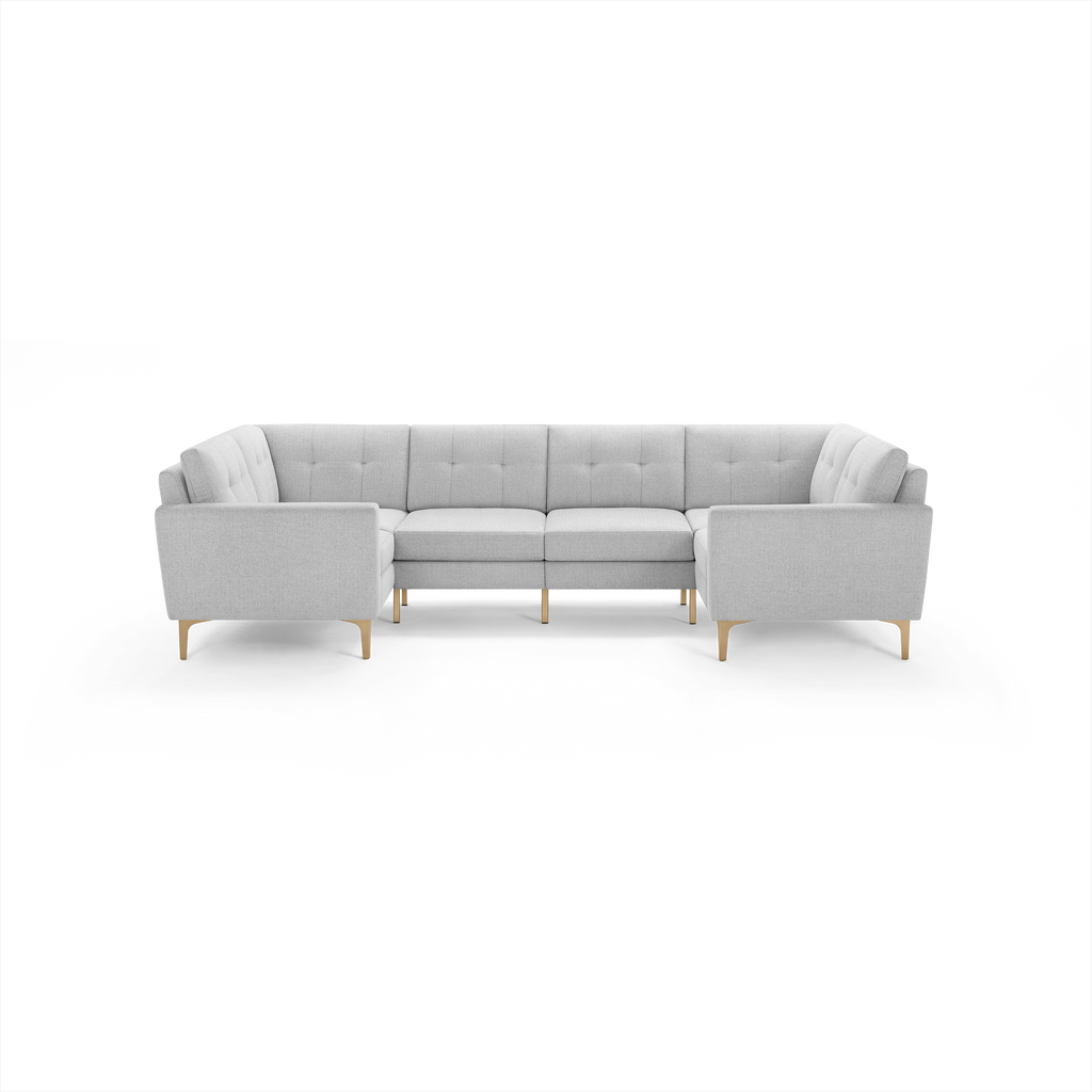 Light gray tufted fabric U-shaped sectional sofa with wooden legs, featuring clean lines and modern design.