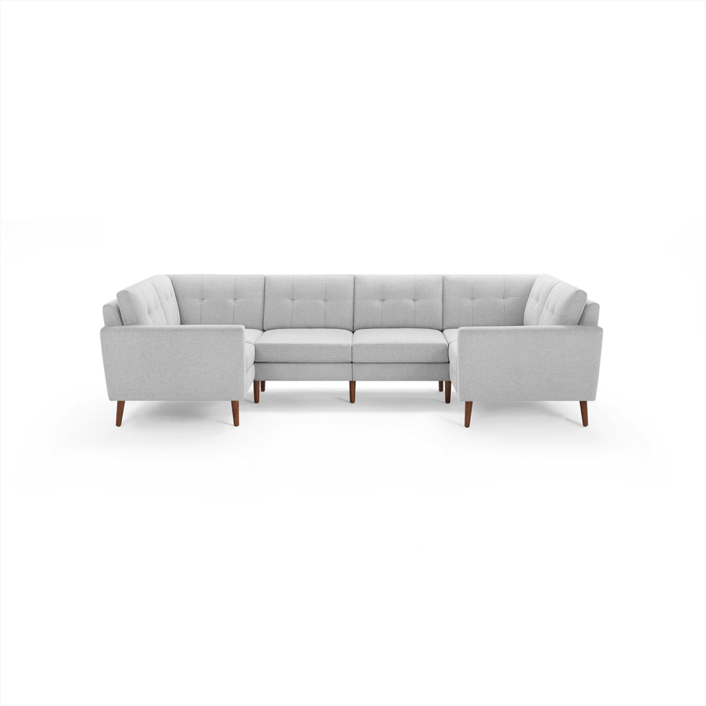 Light gray upholstered sectional sofa with tufted cushions, wooden legs, and modern clean lines, designed for large living spaces.