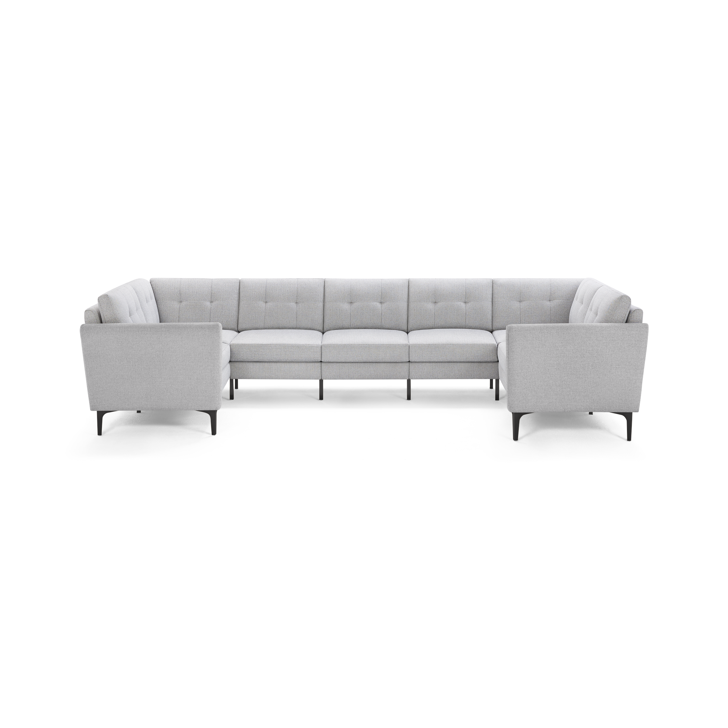 Light gray, modern U-shaped sectional sofa with tufted back cushions and slim dark legs, providing ample seating.