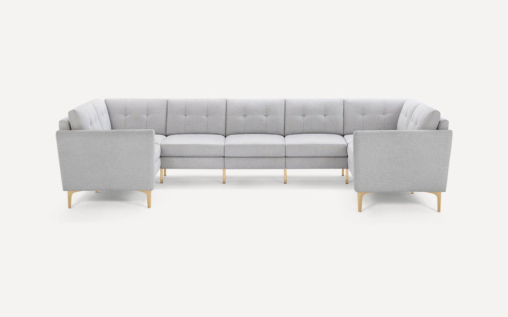 Light gray modern sectional sofa with tufted cushions and light wooden legs, arranged in a U-shape on a white background.