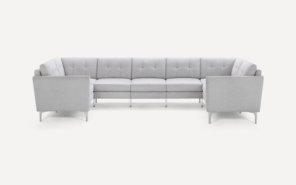 Light gray fabric U-shaped sectional sofa with tufted cushions and metal legs, set against a plain white background.