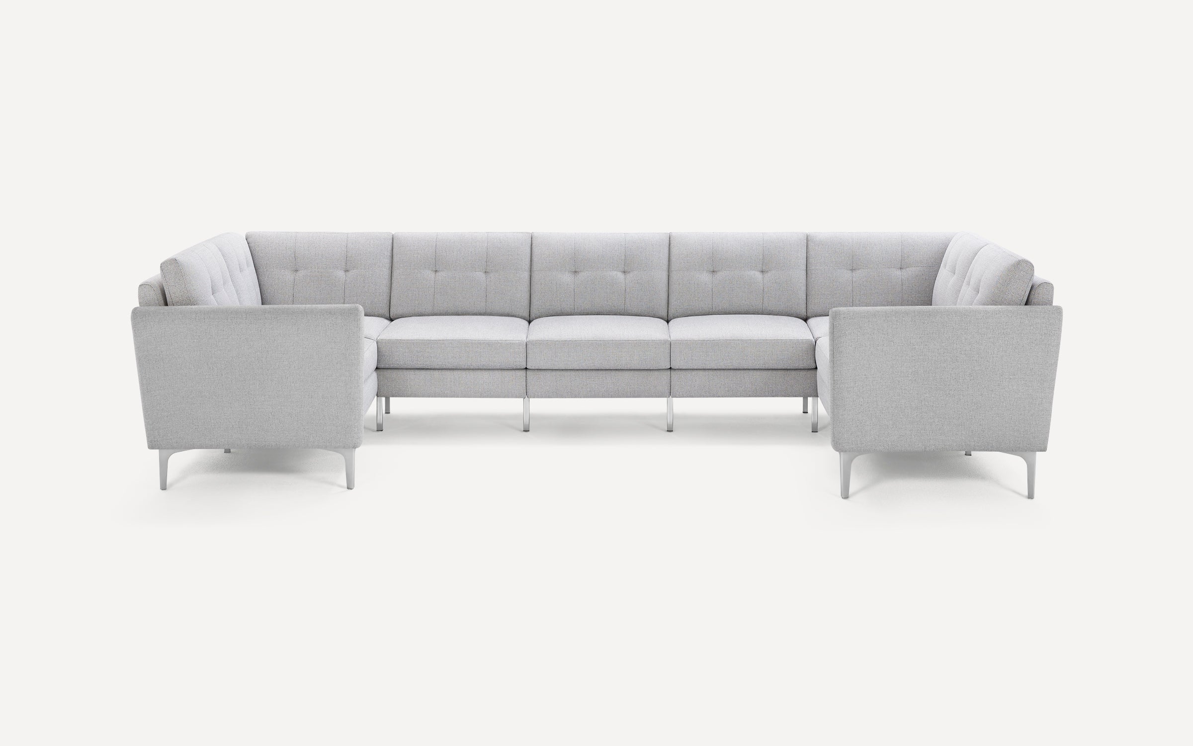 Light gray fabric U-shaped sectional sofa with tufted cushions and metal legs, set against a plain white background.