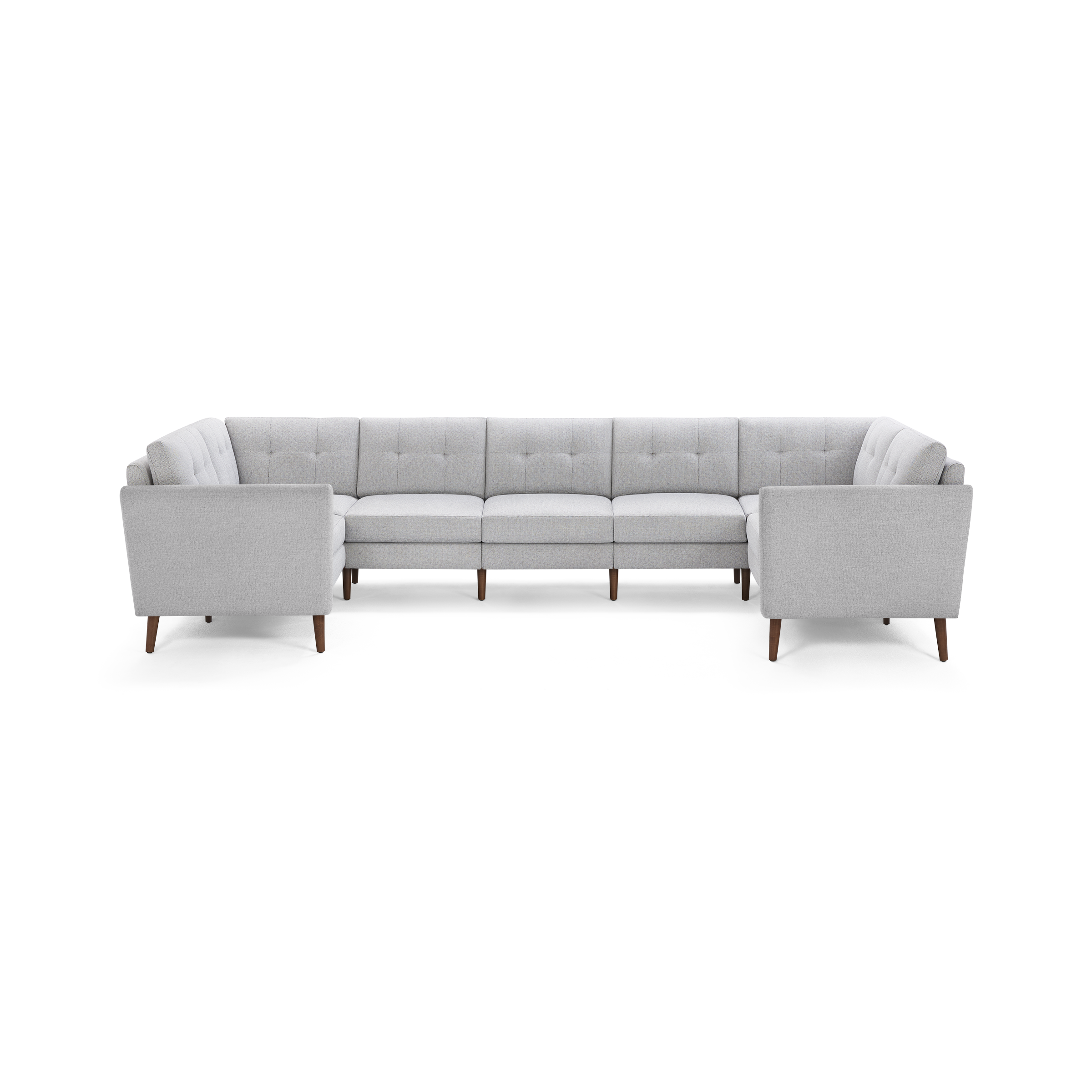 Light gray upholstered L-shaped sectional sofa with tufted back cushions and tapered wooden legs.