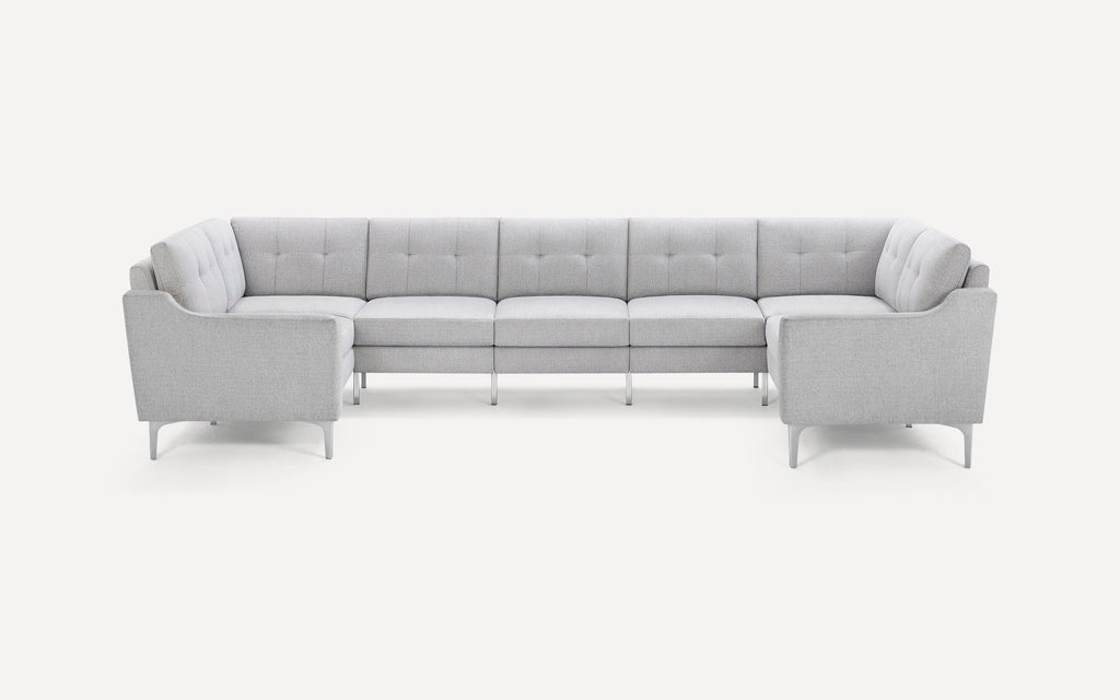 Modern light gray fabric sectional sofa with tufted cushions and sleek metal legs, arranged in a spacious U-shape design.