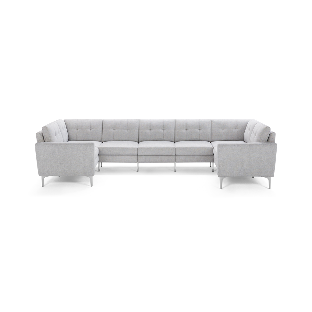 Light gray upholstered sectional sofa with tufted back cushions and metal legs, arranged in a U-shape.
