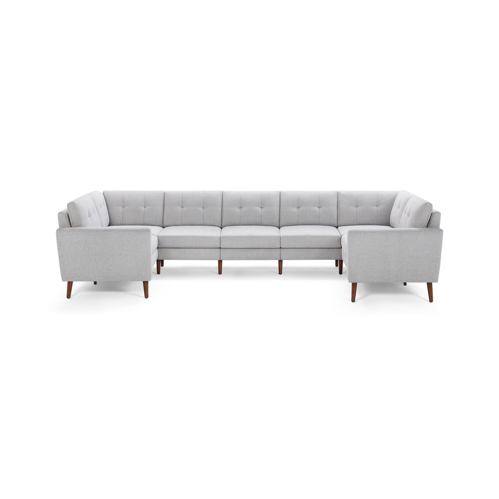 Light gray L-shaped sectional sofa with tufted cushions and wooden tapered legs, offering modern and spacious seating.