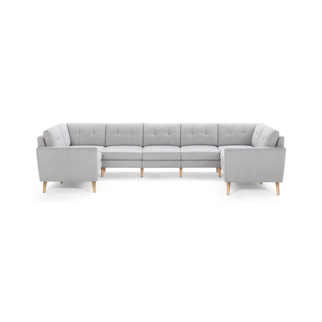 Light gray U-shaped sectional sofa with tufted cushions, straight armrests, and wooden legs, designed for spacious seating.